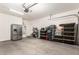 Tidy garage with overhead lighting, water heater, refrigerator, and storage containers at 6746 W Wethersfield Rd, Peoria, AZ 85381