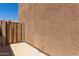 Side yard featuring a wooden gate and stucco wall for privacy and security at 6746 W Wethersfield Rd, Peoria, AZ 85381