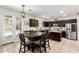 Bright kitchen and dining area with stainless steel appliances and a breakfast bar island at 6746 W Wethersfield Rd, Peoria, AZ 85381