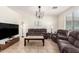 Inviting living room featuring comfortable seating and a ceiling fan at 6746 W Wethersfield Rd, Peoria, AZ 85381