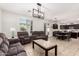 Spacious living room featuring tile floors, comfortable seating, and a modern chandelier at 6746 W Wethersfield Rd, Peoria, AZ 85381