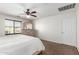 Bright bedroom features a ceiling fan and neutral carpeting at 6746 W Wethersfield Rd, Peoria, AZ 85381