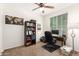 Well-lit office space with a desk, bookcase, and comfortable office chair at 6746 W Wethersfield Rd, Peoria, AZ 85381