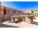 Backyard featuring a built-in outdoor kitchen with a grill and counter space at 6746 W Wethersfield Rd, Peoria, AZ 85381