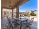 Covered patio featuring an outdoor dining set and a built-in BBQ area for entertaining at 6746 W Wethersfield Rd, Peoria, AZ 85381