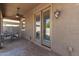 Covered patio with ceiling fan and outdoor seating area with access through double doors at 6746 W Wethersfield Rd, Peoria, AZ 85381