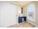 Bedroom featuring a built in desk and storage beside a window with shutters at 6831 S Coral Gable Dr, Chandler, AZ 85249