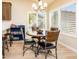 Cozy dining area featuring a modern chandelier, and backyard views from large windows at 6831 S Coral Gable Dr, Chandler, AZ 85249