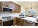 Modern kitchen showcasing stainless steel appliances, solid countertops, and wood cabinets at 6831 S Coral Gable Dr, Chandler, AZ 85249