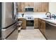 Bright kitchen featuring stainless steel appliances, granite countertops, and tile backsplash at 6831 S Coral Gable Dr, Chandler, AZ 85249