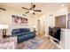 Open living area with a comfortable sofa, ceiling fan, and access to the kitchen at 6831 S Coral Gable Dr, Chandler, AZ 85249