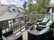 Inviting outdoor balcony featuring comfortable seating, a glass table, and a scenic neighborhood view at 7272 E Gainey Ranch Rd # 121, Scottsdale, AZ 85258