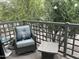Relaxing balcony area with comfortable chair and outdoor furniture, surrounded by lush greenery at 7272 E Gainey Ranch Rd # 121, Scottsdale, AZ 85258