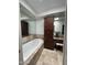 Bright bathroom featuring a tub with tile surround and a vanity with storage at 7272 E Gainey Ranch Rd # 121, Scottsdale, AZ 85258