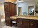 Beautiful bathroom with granite counters, wood cabinets, and a vanity area at 7272 E Gainey Ranch Rd # 121, Scottsdale, AZ 85258