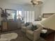 Spacious bedroom featuring a large dresser, comfortable seating, and natural light at 7272 E Gainey Ranch Rd # 121, Scottsdale, AZ 85258