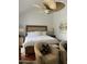 Bright bedroom with high ceilings, ceiling fan, hardwood floors and cozy sitting area at 7272 E Gainey Ranch Rd # 121, Scottsdale, AZ 85258