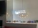 Modern chandelier hangs above the wall display featuring decorative items and a mirrored backdrop at 7272 E Gainey Ranch Rd # 121, Scottsdale, AZ 85258