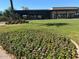 Beautiful community clubhouse with covered patio, manicured lawn, and vibrant flower beds, perfect for social gatherings at 7272 E Gainey Ranch Rd # 121, Scottsdale, AZ 85258