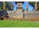 Community sign for Gainey Ranch, featuring beautiful landscaping with a stone and metal sign at 7272 E Gainey Ranch Rd # 121, Scottsdale, AZ 85258