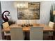Dining room with modern chandelier, seating for six and art on the wall at 7272 E Gainey Ranch Rd # 121, Scottsdale, AZ 85258