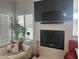 Modern fireplace with a large television and stylish decor at 7272 E Gainey Ranch Rd # 121, Scottsdale, AZ 85258