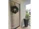 Inviting front door with a decorative wreath and planter box at 7272 E Gainey Ranch Rd # 121, Scottsdale, AZ 85258