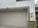 Two car garage with stone accent, address number 121 on a white stucco home at 7272 E Gainey Ranch Rd # 121, Scottsdale, AZ 85258