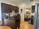 Kitchen features wood cabinets, stainless appliances and an eat-in dining area at 7272 E Gainey Ranch Rd # 121, Scottsdale, AZ 85258