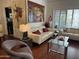 A well-lit living room with art, white couches and a glass coffee table at 7272 E Gainey Ranch Rd # 121, Scottsdale, AZ 85258