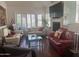 Comfortable living room with modern decor, a fireplace, and large windows providing ample natural light at 7272 E Gainey Ranch Rd # 121, Scottsdale, AZ 85258
