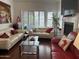 Bright living room with hardwood floors, fireplace and large windows at 7272 E Gainey Ranch Rd # 121, Scottsdale, AZ 85258