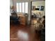 Inviting office space with hardwood floors, desk, and view of living area at 7272 E Gainey Ranch Rd # 121, Scottsdale, AZ 85258