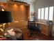 Functional home office with built-in desk, storage, and comfortable seating area at 7272 E Gainey Ranch Rd # 121, Scottsdale, AZ 85258