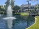 Scenic view of a pond and nearby residences under a clear blue sky at 7272 E Gainey Ranch Rd # 121, Scottsdale, AZ 85258