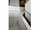 Staircase with wooden steps and sleek metal handrail at 7272 E Gainey Ranch Rd # 121, Scottsdale, AZ 85258