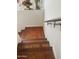 Hardwood stairs offer a timeless aesthetic appeal, providing an elegant transition between levels of the home at 7272 E Gainey Ranch Rd # 121, Scottsdale, AZ 85258