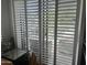 Window with white shutters providing ample natural light and views of the neighborhood at 7272 E Gainey Ranch Rd # 121, Scottsdale, AZ 85258