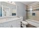 Bathroom with a new vanity and countertop, a mirror and a bathtub with tile surround and glass doors at 7575 E Indian Bend Rd # 2002, Scottsdale, AZ 85250