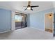 Light-filled bedroom with soft blue walls, sliding glass doors and neutral carpet at 7575 E Indian Bend Rd # 2002, Scottsdale, AZ 85250