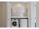 Convenient laundry area featuring a stacked washer and dryer and additional storage space at 7575 E Indian Bend Rd # 2002, Scottsdale, AZ 85250