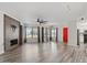 Bright living room with a fireplace, ceiling fan, wood floors and large windows offering plenty of natural light at 7575 E Indian Bend Rd # 2002, Scottsdale, AZ 85250