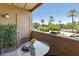 Cozy balcony with a view of lush green trees and a parking lot at 7575 E Indian Bend Rd # 2002, Scottsdale, AZ 85250