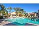 Resort-style pool surrounded by lush landscaping and comfortable lounge chairs at 7575 E Indian Bend Rd # 2002, Scottsdale, AZ 85250