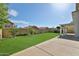 The lawn and landscaping in the back yard look onto the rear of the home and covered patio at 7633 W Kristal Way, Glendale, AZ 85308
