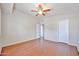 This bedroom has hardwood floors, a ceiling fan, and white walls and doors at 7633 W Kristal Way, Glendale, AZ 85308