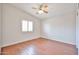A bedroom with a window with shutter style covering, hardwood floors, and ceiling fan at 7633 W Kristal Way, Glendale, AZ 85308