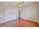 This bedroom has hardwood floors and a ceiling fan, and closet with sliding doors at 7633 W Kristal Way, Glendale, AZ 85308