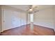 Bedroom with wood floors, large closet, and neutral colored walls and trim at 7633 W Kristal Way, Glendale, AZ 85308