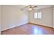 This bedroom features a ceiling fan, light walls, and a window with shutters at 7633 W Kristal Way, Glendale, AZ 85308
